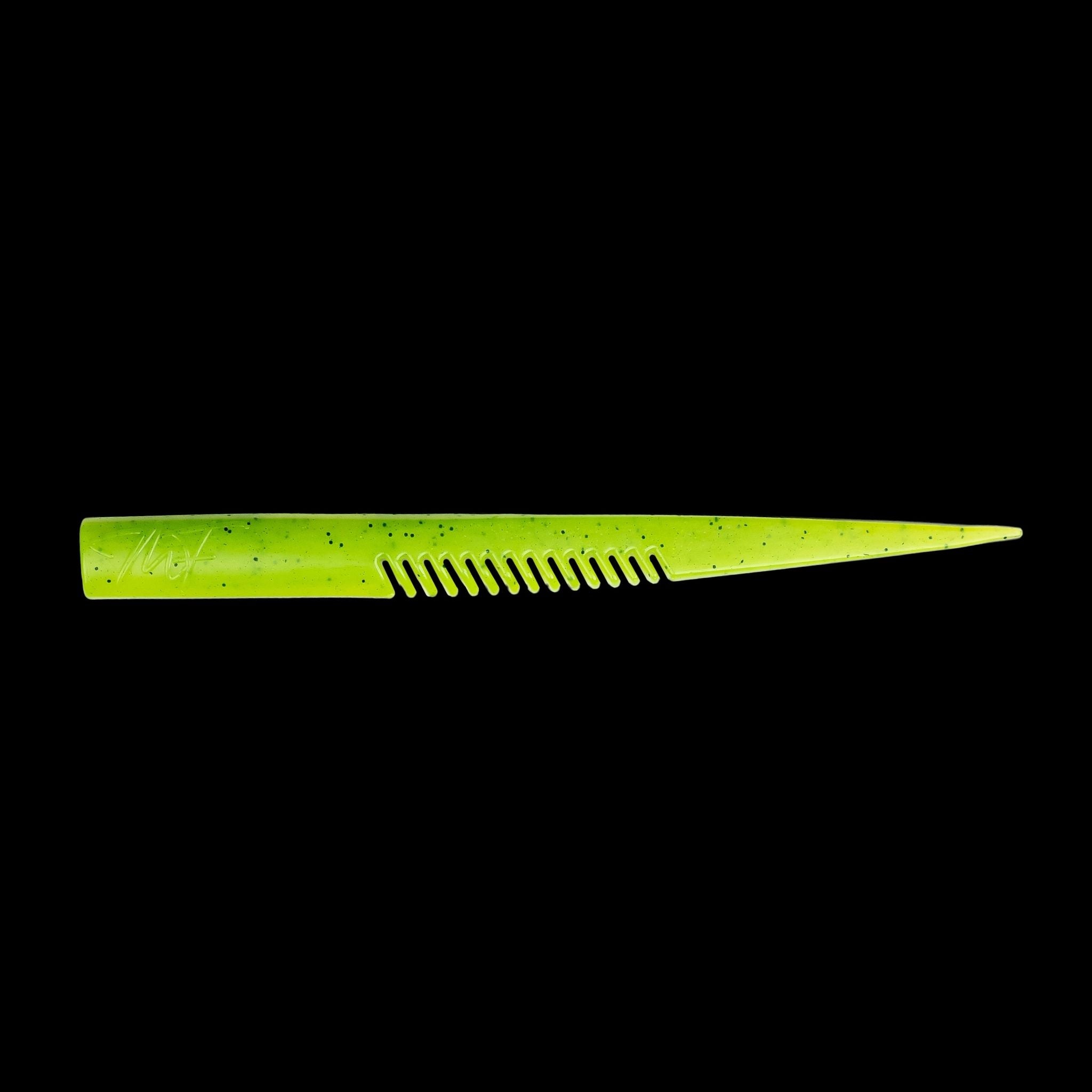 yellow comb-like texture fishing lure on a black background