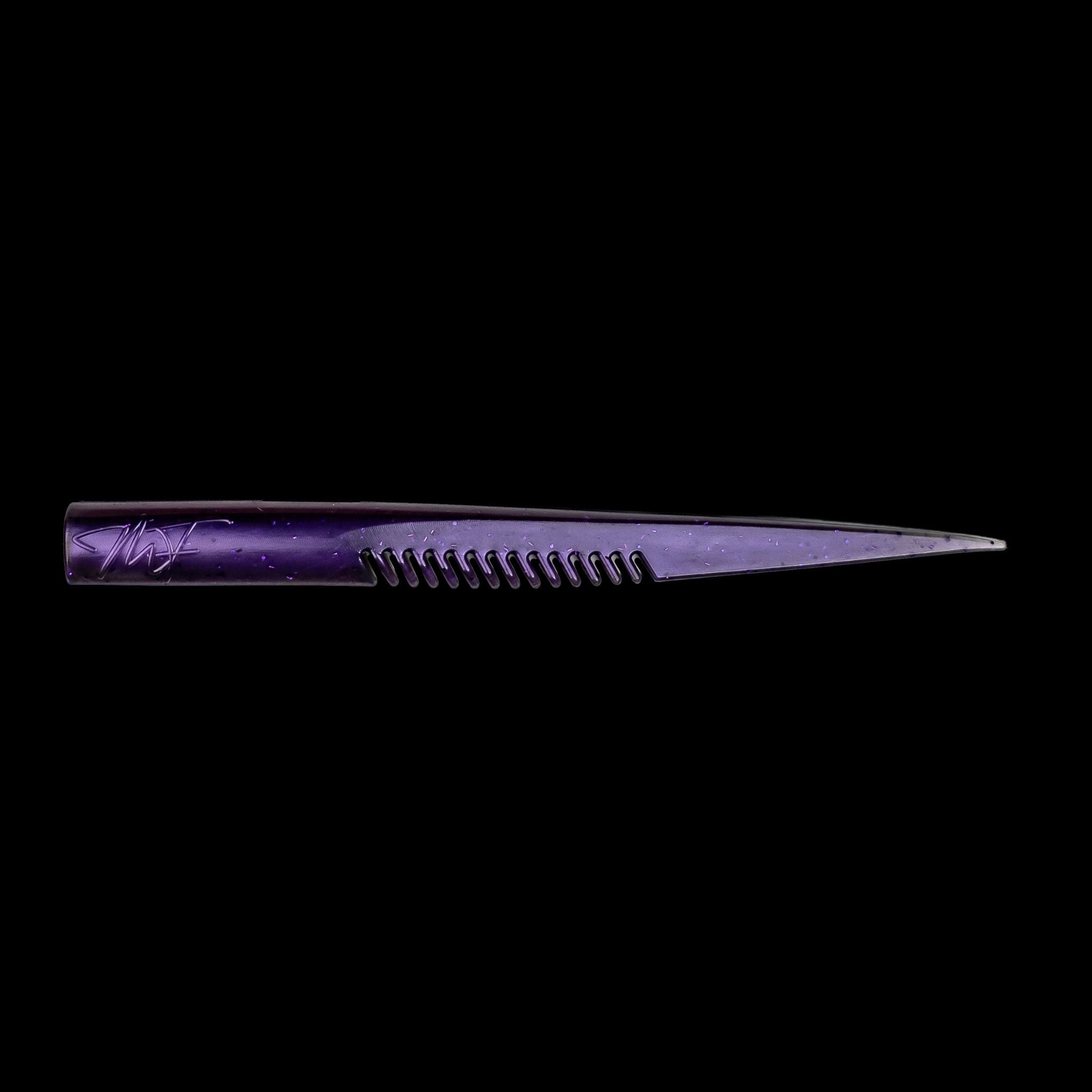Purple comb-like texture fishing lure on a black background