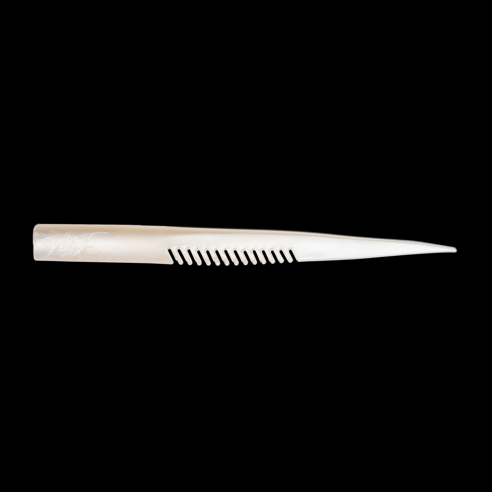 white comb-like texture fishing lure on a black background
