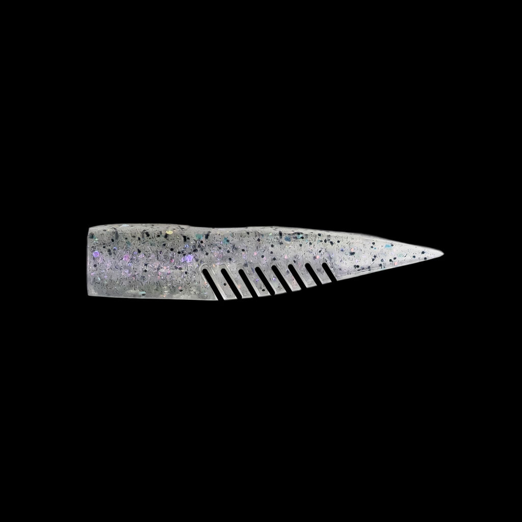 silver comb-like texture fishing lure on a black background