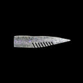 silver comb-like texture fishing lure on a black background