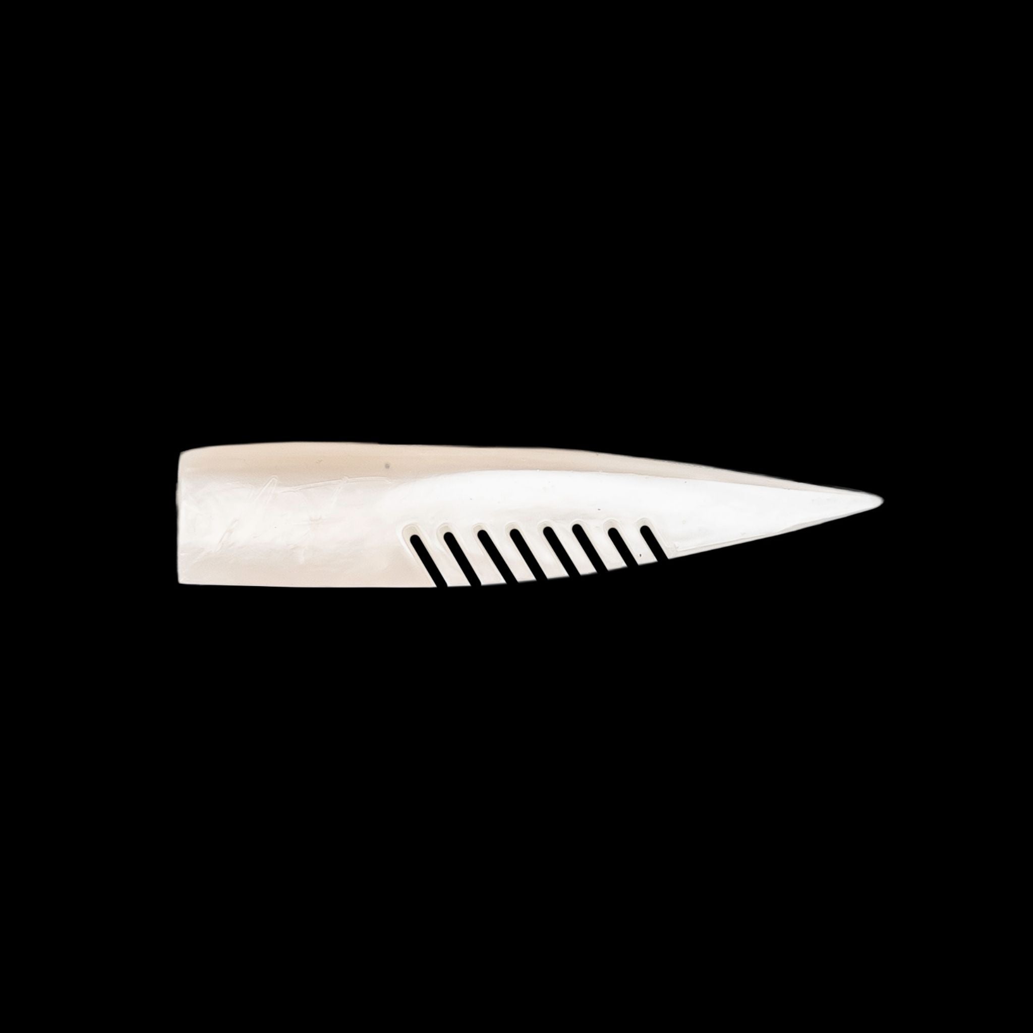 white comb-like texture fishing lure on a black background
