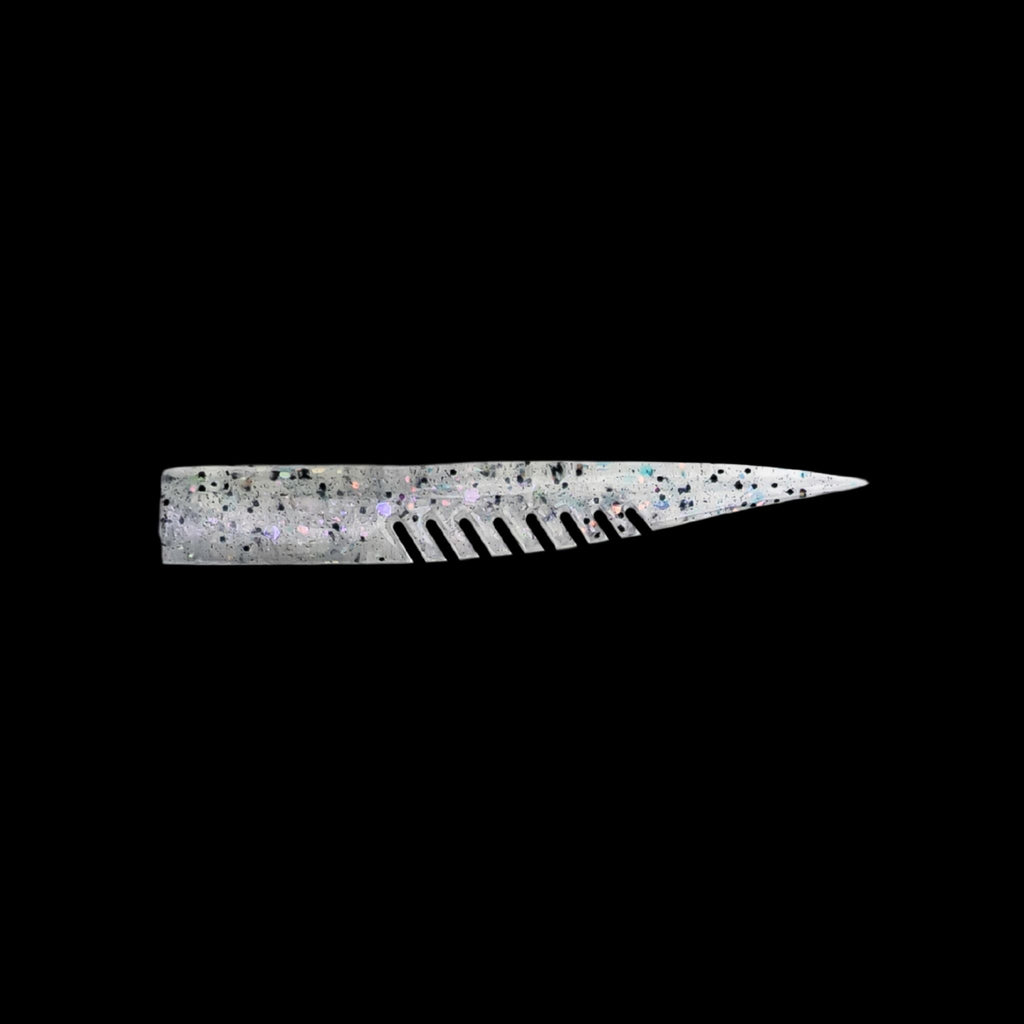 silver fishing lure with a comb-like texture on a black background