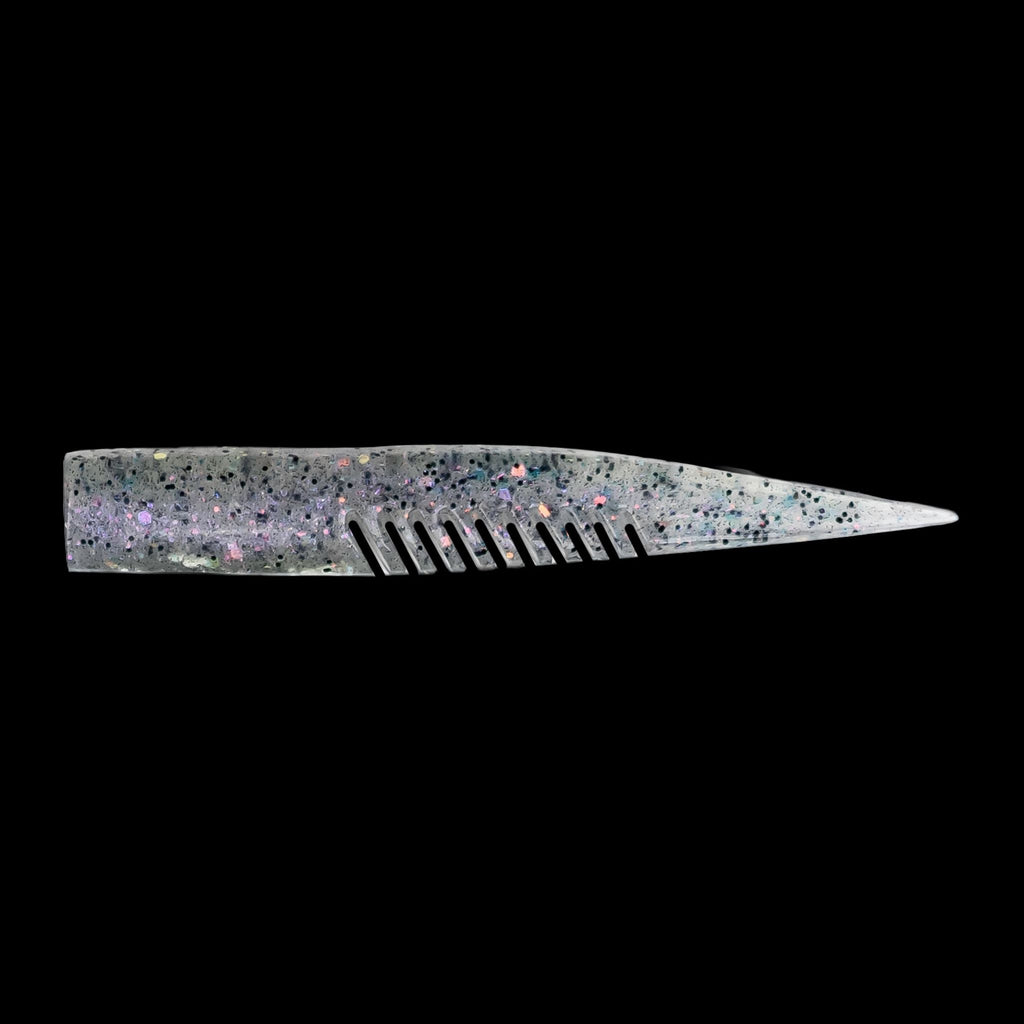 silver comb-like texture fishing lure on a black background