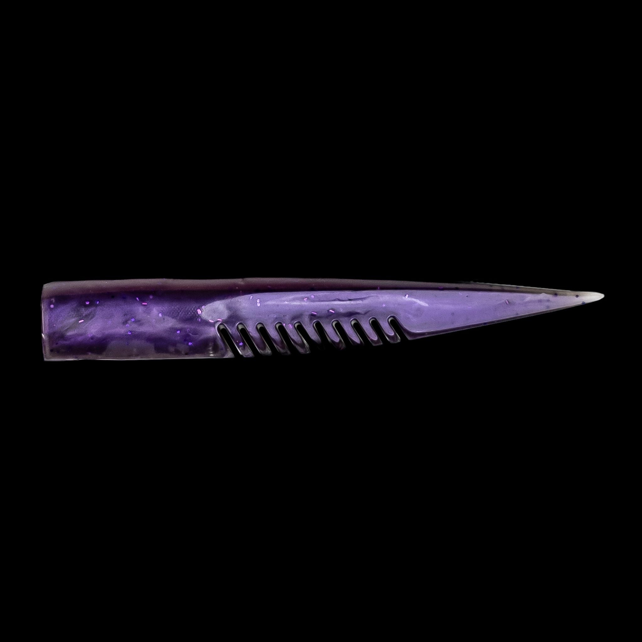 Purple comb-like texture fishing lure on a black background