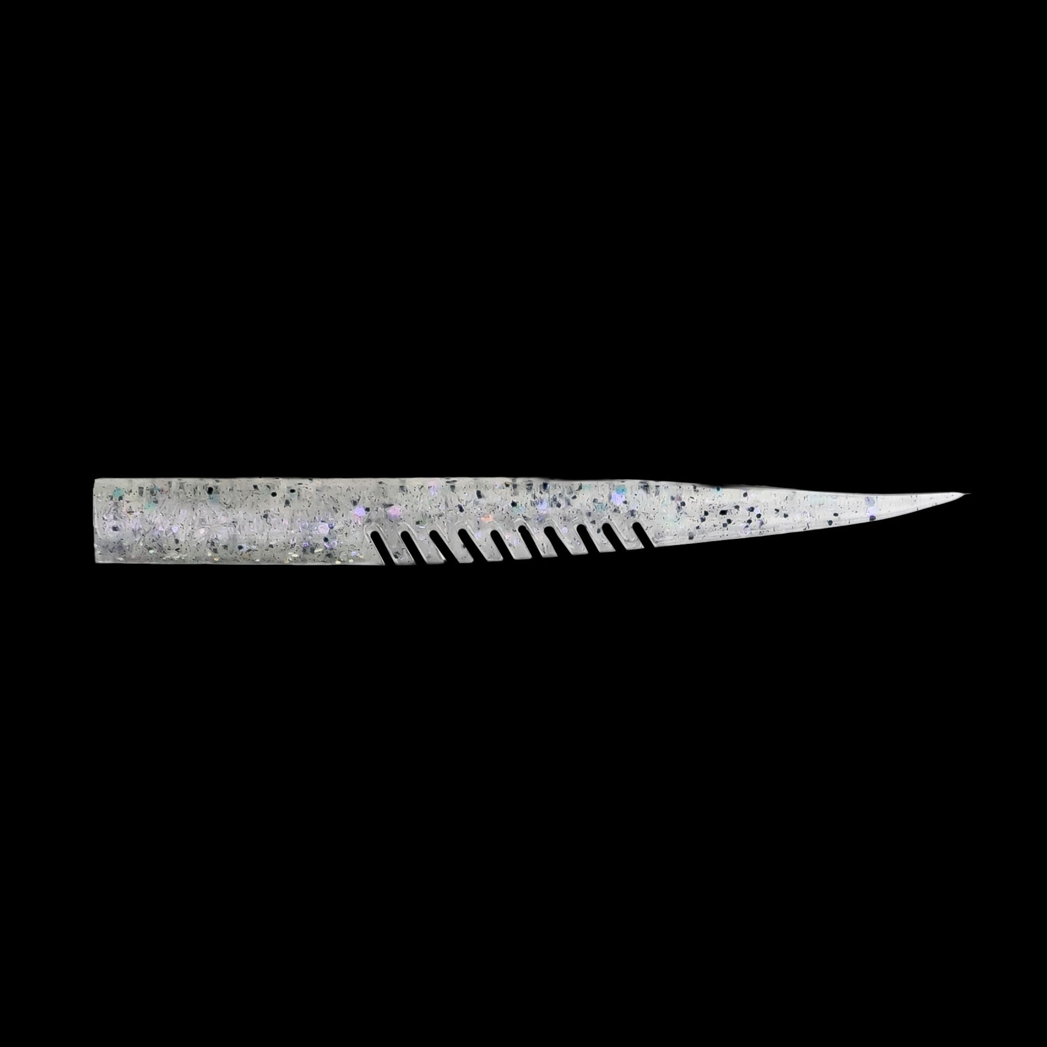 silver fishing lure with a comb-like texture on a black background