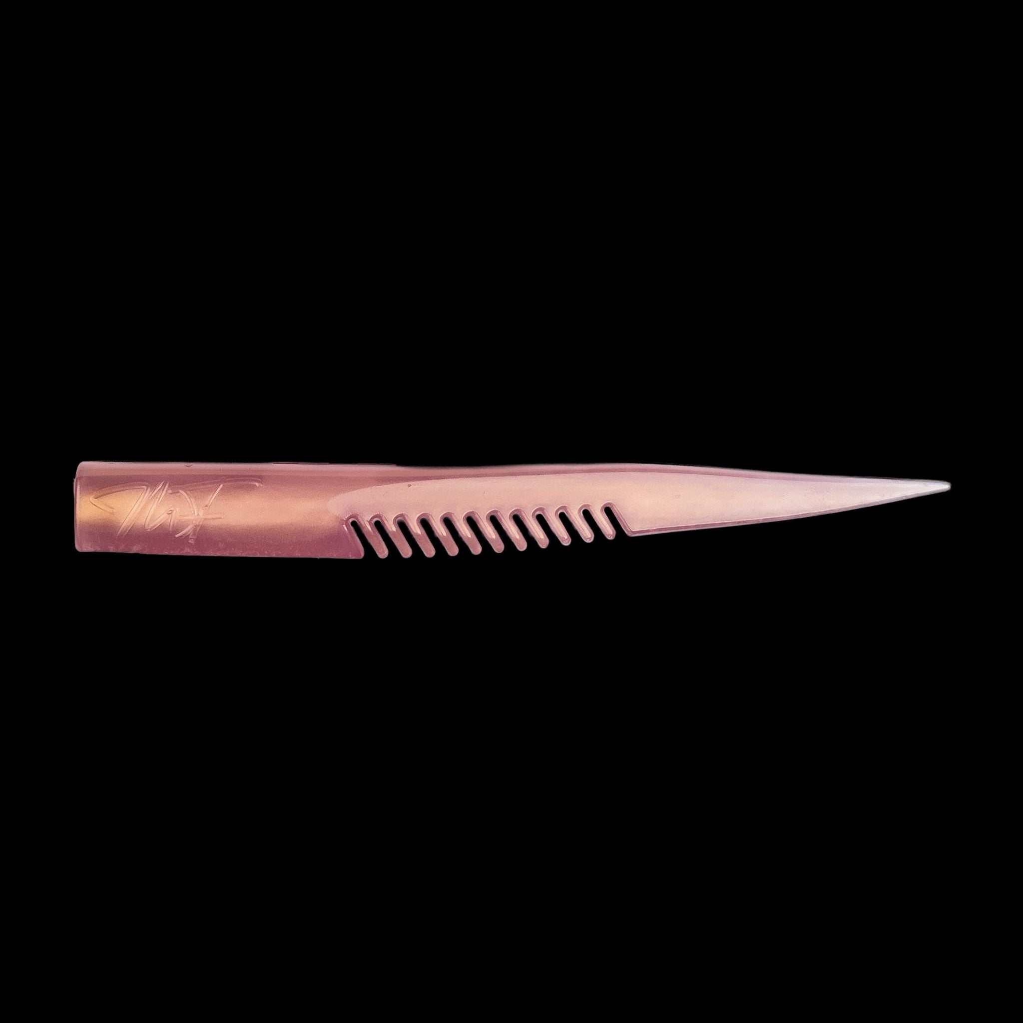 pink comb-like texture fishing lure on a black background