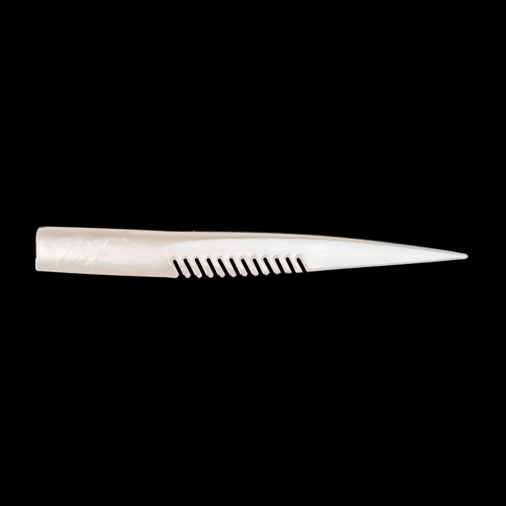 white comb-like texture fishing lure on a black background