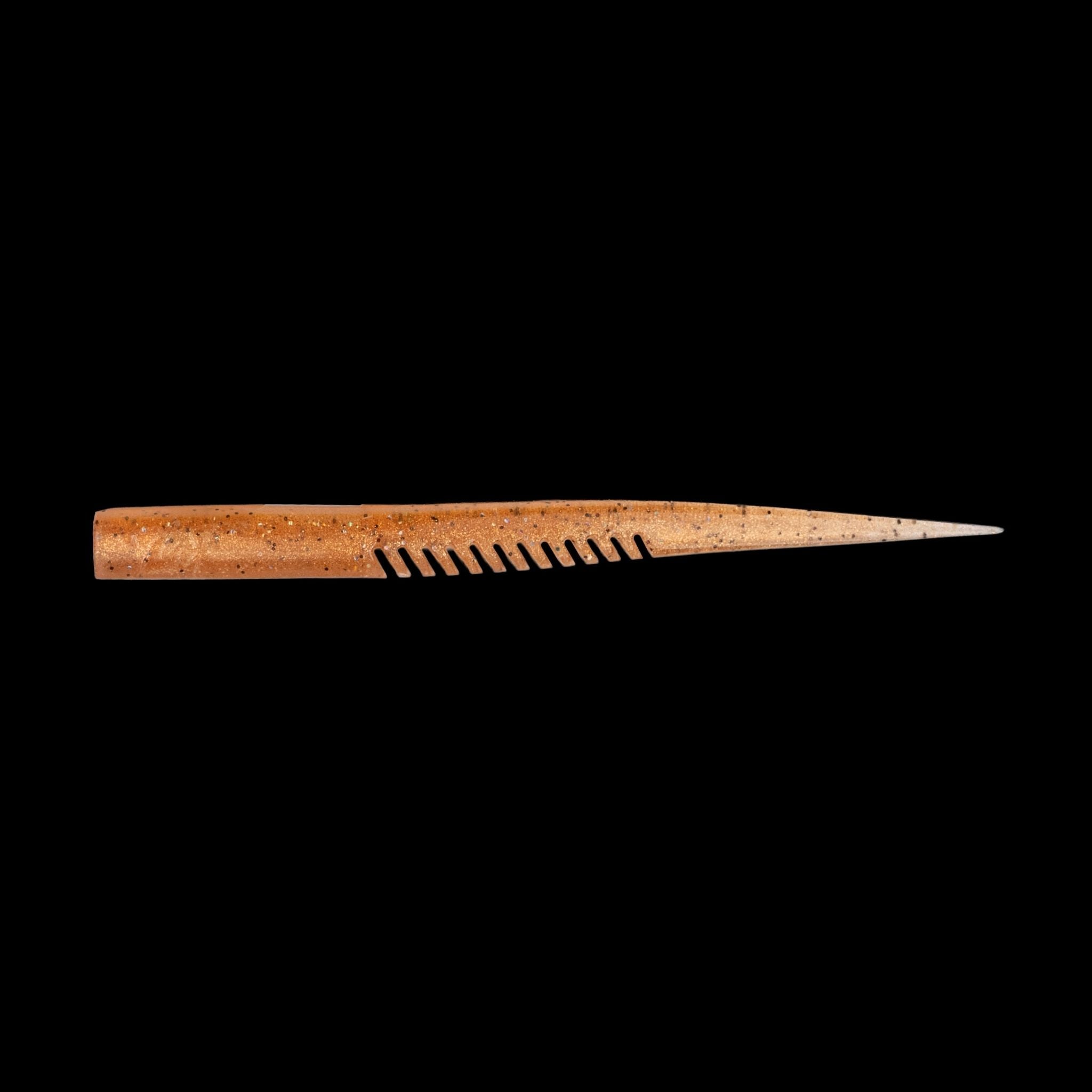 brown fishing lure with a comb-like texture on a black background