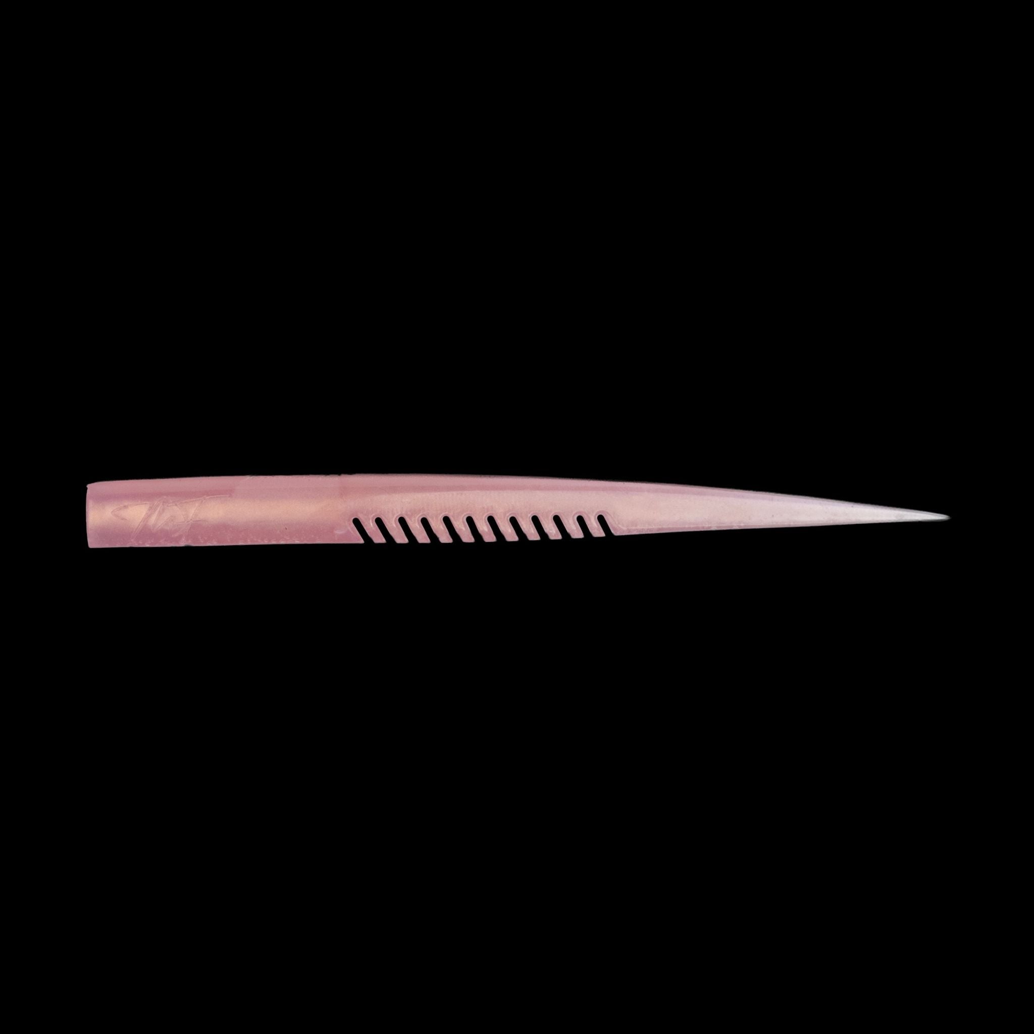 pink fishing lure on black background